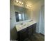 Bathroom featuring a double sink vanity with marble countertop and dark wood cabinets at 10231 E Illini St, Mesa, AZ 85208