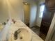 Bathroom featuring a double sink vanity with marble countertop and dark wood cabinets at 10231 E Illini St, Mesa, AZ 85208