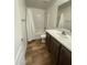 Charming bathroom with wood-look flooring, tub, shower, and dark vanity with bright countertop at 10231 E Illini St, Mesa, AZ 85208