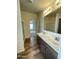 Spacious bathroom with double sinks, dark wood cabinets, and a view into the bedroom at 10231 E Illini St, Mesa, AZ 85208