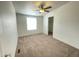 Cozy bedroom featuring a ceiling fan and a window for natural light, and a walk-in closet at 10231 E Illini St, Mesa, AZ 85208