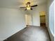 This bedroom features a ceiling fan, neutral carpet, and a walk-in closet for ample storage at 10231 E Illini St, Mesa, AZ 85208