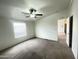 Bright bedroom featuring a ceiling fan and a large window with blinds for natural light at 10231 E Illini St, Mesa, AZ 85208
