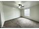 Bright bedroom with neutral carpet, a ceiling fan, and natural light from the window at 10231 E Illini St, Mesa, AZ 85208