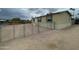 Tan home with chain link fence surrounding a gravel yard with front door at 10231 E Illini St, Mesa, AZ 85208