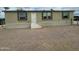 Tan home featuring three windows and a front entrance with a gravel lot at 10231 E Illini St, Mesa, AZ 85208