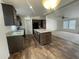 Kitchen with island, tile floor, dark cabinets, black appliances, and opens to the living room at 10231 E Illini St, Mesa, AZ 85208