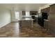 Eat-in kitchen with tile floors, an island, black appliances, and plenty of cabinet space at 10231 E Illini St, Mesa, AZ 85208