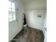 Functional laundry room with tile flooring, storage shelves, and a convenient door to the outside at 10231 E Illini St, Mesa, AZ 85208