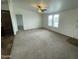 Spacious living room with carpet, ceiling fan, and large windows at 10231 E Illini St, Mesa, AZ 85208