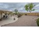 A view of the desert landscaped back yard, the covered patio, and other desert plants at 11012 E Knowles Ave, Mesa, AZ 85209