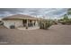 A view of the back exterior of the home, with desert landscaping and a covered patio at 11012 E Knowles Ave, Mesa, AZ 85209