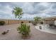 This home features a spacious back yard with desert landscaping, a covered patio, and privacy wall at 11012 E Knowles Ave, Mesa, AZ 85209