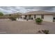 This is a view of the back yard of the home with desert landscaping and covered patio at 11012 E Knowles Ave, Mesa, AZ 85209