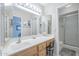 A light and bright bathroom with a large vanity with mirror, and a glass enclosed shower at 11012 E Knowles Ave, Mesa, AZ 85209
