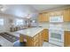 Well-equipped kitchen with an island, seamlessly connecting to the living area at 11012 E Knowles Ave, Mesa, AZ 85209