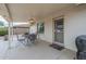 A covered patio space featuring an outdoor dining set and a view of the back yard at 11012 E Knowles Ave, Mesa, AZ 85209