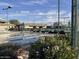 Beautifully maintained tennis courts with serene landscaping and flowering plants at 11012 E Knowles Ave, Mesa, AZ 85209