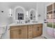 Stylish bathroom with double vanity, modern lighting, and door to exterior at 1142 E Encinas Ave, Gilbert, AZ 85234