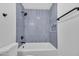 Tiled tub and shower combo with black hardware and a built-in shelf at 1142 E Encinas Ave, Gilbert, AZ 85234