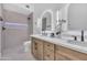 Modern bathroom features double sinks, backlit mirrors, and a tiled walk-in shower with sleek fixtures at 1142 E Encinas Ave, Gilbert, AZ 85234