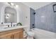 Well-lit bathroom featuring a stylish vanity and modern, tiled shower-tub combo with black hardware at 1142 E Encinas Ave, Gilbert, AZ 85234