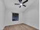The empty bedroom has wood floors and a ceiling fan at 1142 E Encinas Ave, Gilbert, AZ 85234