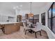 Dining area with modern chandelier, wooden cabinets, and plenty of natural light at 1142 E Encinas Ave, Gilbert, AZ 85234