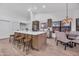 Stylish kitchen boasts island seating, stainless appliances, and an adjacent dining area perfect for gatherings at 1142 E Encinas Ave, Gilbert, AZ 85234
