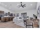 Bright living room featuring an open floor plan, ceiling fan, and sliding glass door to the backyard at 1142 E Encinas Ave, Gilbert, AZ 85234
