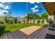 Beautiful backyard with a putting green and a spacious patio perfect for outdoor entertaining under a sunny sky at 12 E Seminole Dr, Phoenix, AZ 85022
