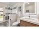 Updated bathroom showcasing a glass-enclosed shower, modern vanity, and stylish geometric flooring at 12 E Seminole Dr, Phoenix, AZ 85022