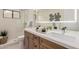 Well-lit bathroom featuring double sinks, modern fixtures, sleek cabinetry and stylish patterned tile floor at 12 E Seminole Dr, Phoenix, AZ 85022