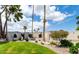 Expansive front yard featuring lush green grass, mature trees, and a well-maintained landscape at 12 E Seminole Dr, Phoenix, AZ 85022