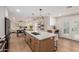Modern kitchen featuring a large island with seating, stainless steel appliances, and open floor plan at 12 E Seminole Dr, Phoenix, AZ 85022