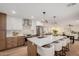 Modern kitchen features a large island with seating, stainless steel appliances, and stylish pendant lighting at 12 E Seminole Dr, Phoenix, AZ 85022