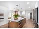 Bright kitchen with stainless steel appliances, large island with seating, and wood cabinets at 12 E Seminole Dr, Phoenix, AZ 85022