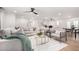 Bright living room featuring modern furniture, a ceiling fan, and an open floor plan at 12 E Seminole Dr, Phoenix, AZ 85022