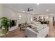 Cozy living room with a fireplace, modern furniture, and an open floor plan connecting to the kitchen at 12 E Seminole Dr, Phoenix, AZ 85022