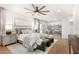 Spacious main bedroom with a ceiling fan, large bed, and seating area at 12 E Seminole Dr, Phoenix, AZ 85022
