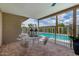 Inviting outdoor patio with a table and chairs, offering views of the sparkling swimming pool at 12 E Seminole Dr, Phoenix, AZ 85022