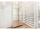 Large walk-in closet featuring custom shelves, mirrored doors, and wood floors for optimal storage at 12 E Seminole Dr, Phoenix, AZ 85022
