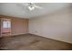 Spacious carpeted bedroom with ceiling fan and closet storage shelves at 13632 N Silverbell Dr, Sun City, AZ 85351