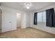 Bright carpeted bedroom with window and closet with folding doors at 13632 N Silverbell Dr, Sun City, AZ 85351