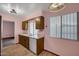 Inviting kitchen featuring a classic sink, wooden cabinets, and neutral walls at 13632 N Silverbell Dr, Sun City, AZ 85351