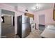 Functional kitchen with stainless steel refrigerator, laminate floors and easy access to other rooms at 13632 N Silverbell Dr, Sun City, AZ 85351