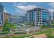 Modern condo building with blue glass windows, lush landscaping, and a resort-style pool at 140 E Rio Salado Pkwy # 402, Tempe, AZ 85281