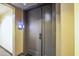 Apartment front door featuring keyless entry and modern design. Hallway view at 140 E Rio Salado Pkwy # 402, Tempe, AZ 85281