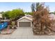 Aerial view of charming single-story home featuring a two-car garage and desert landscaping at 15715 W Cottonwood St, Surprise, AZ 85374