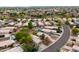 Scenic aerial shot showcasing a neighborhood with mature trees, paved streets, and diverse home designs at 15715 W Cottonwood St, Surprise, AZ 85374